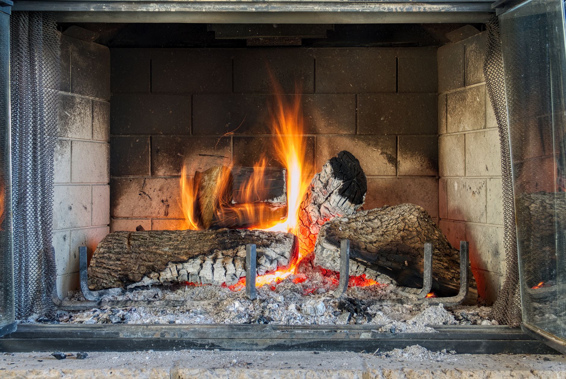 Cozy living room fireplace burning on a winter evening — fireplace winter checklist for homeowners