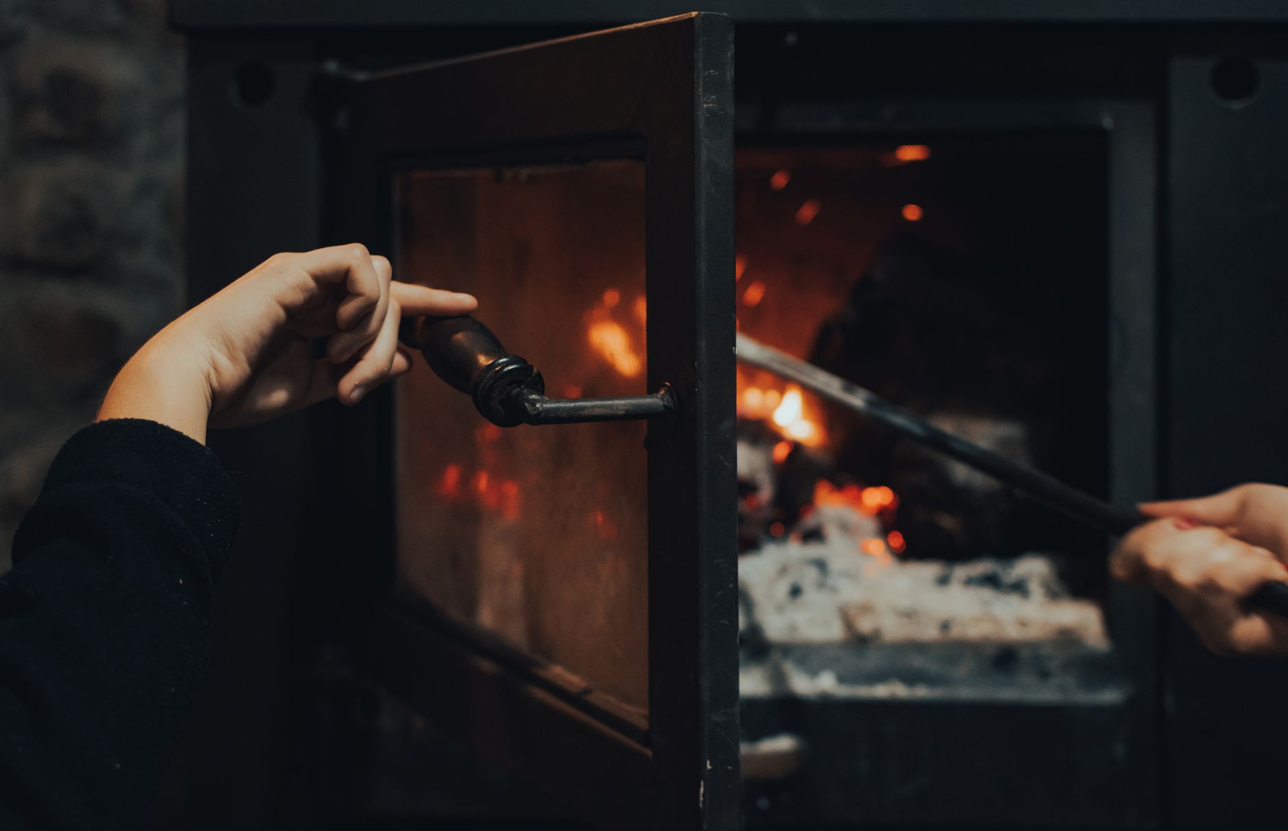 Close-up of a fireplace glass door with dark soot — why fireplace glass turns black