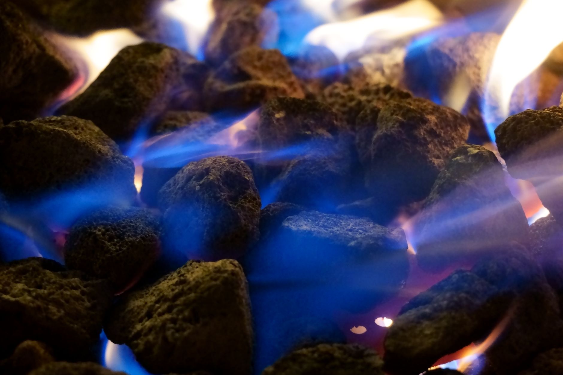 Close-up of blue and orange gas flames — gas fireplace cleaning and maintenance guide